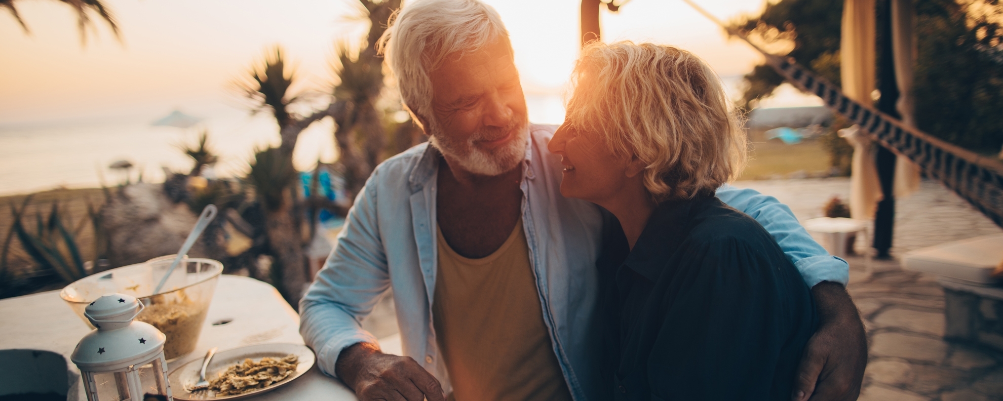 Senior couple having dinner at the beach